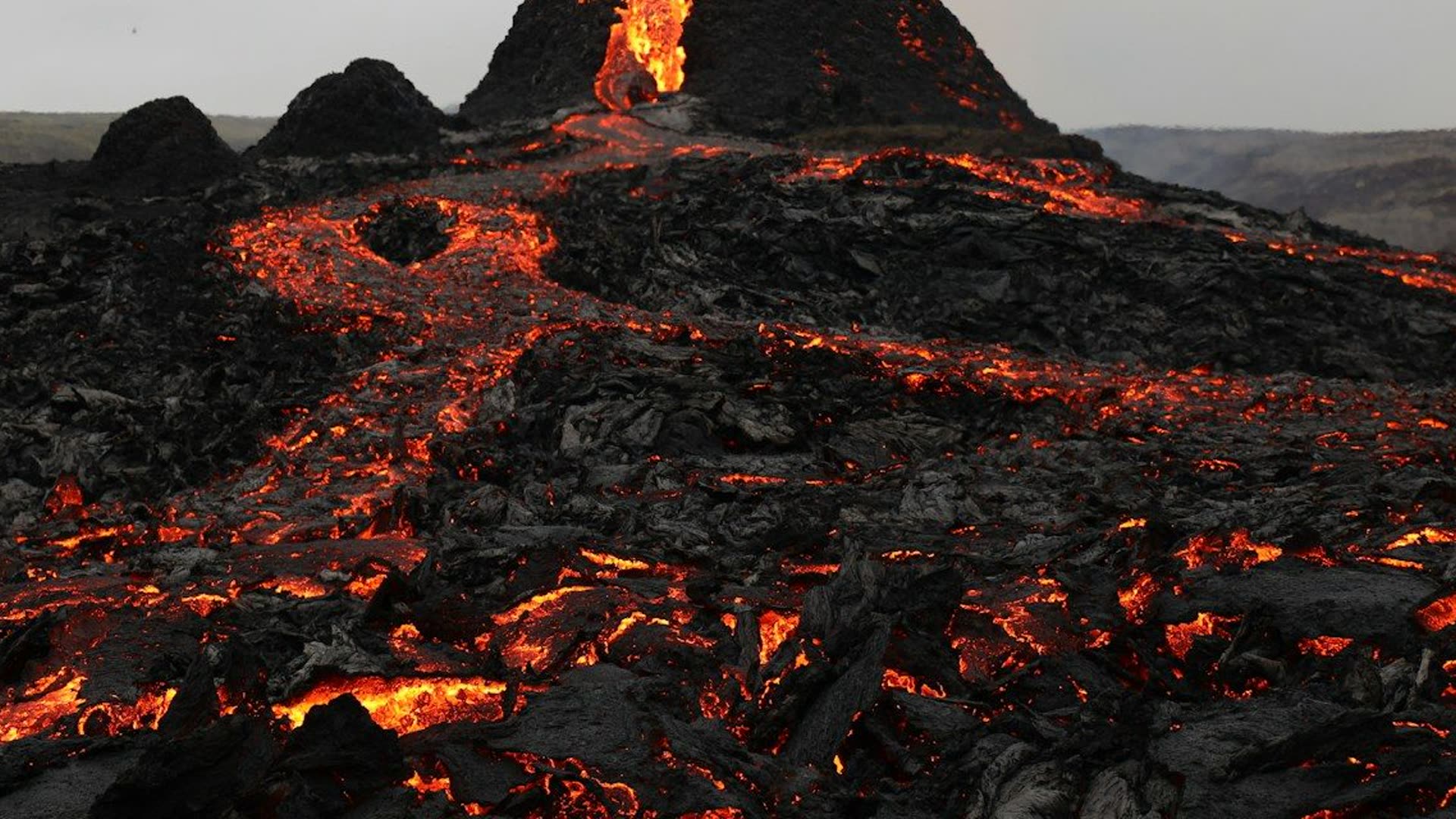 Lava flowing from an erupting volcano